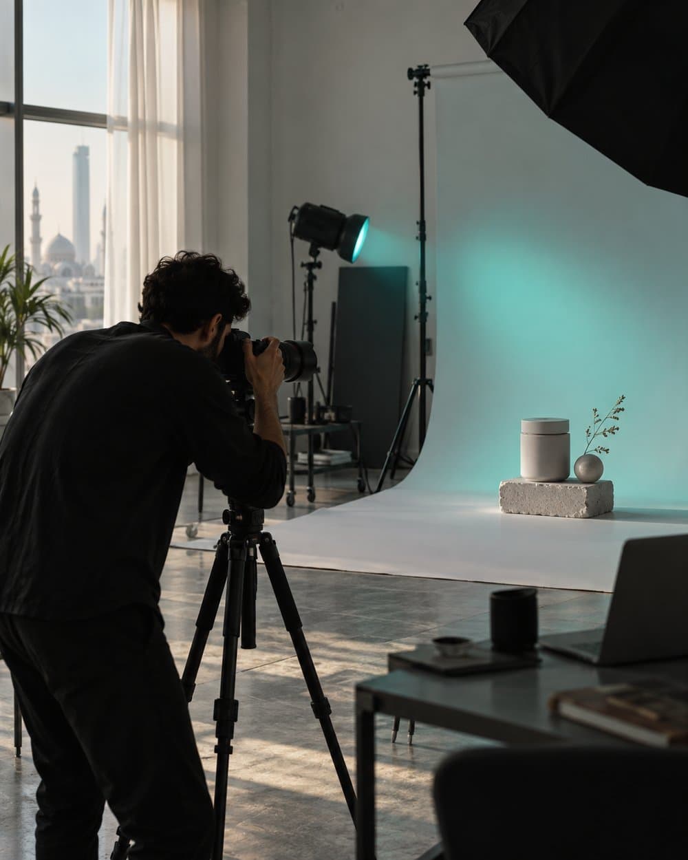 Photographer in the FiKRA 360 studio shooting a product on a white backdrop